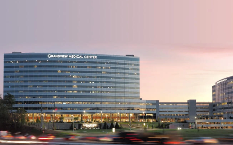 photograph of a hospital at night from a distance