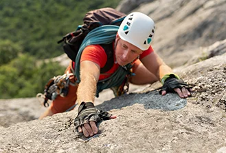 man climbing mountain