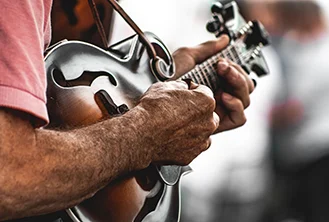 closeup of a person playing the guitar