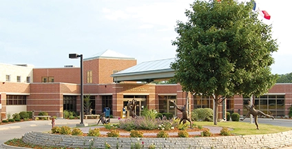 brick building next to a tree