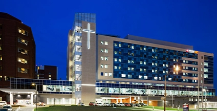 night image of a building that has an illuminated cross