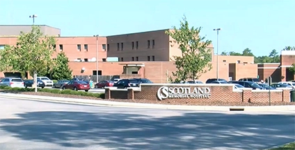 Brick hospital building with signage reading 