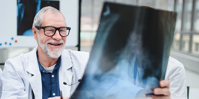 Photograph of a doctor examining an x-ray