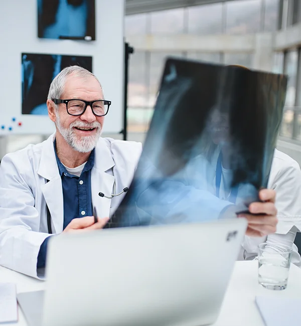 Photograph of a doctor examining an x-ray
