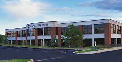 Two-story brick building with large windows, labeled 