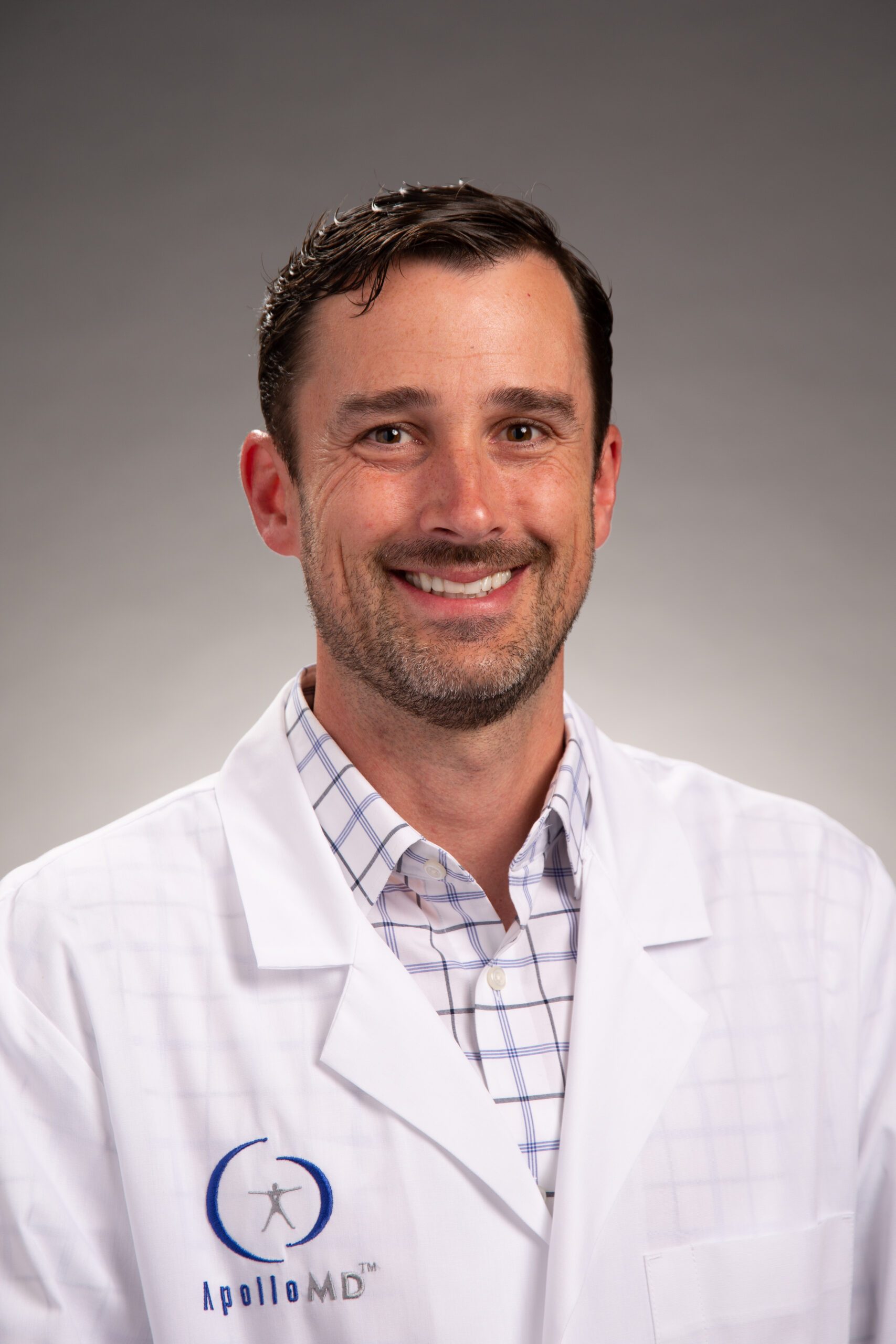 headshot of Dr. John Wood, in a white coat.